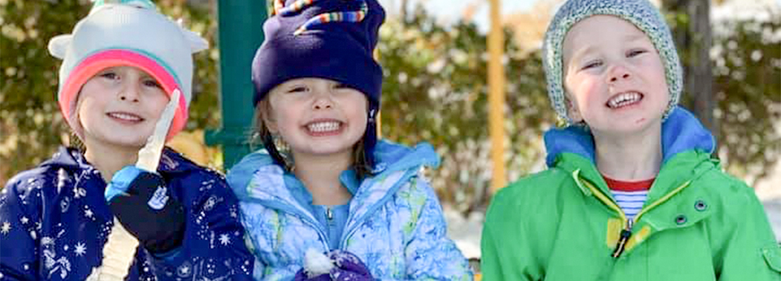 CEC Early Learning Academy students smiling in the snow